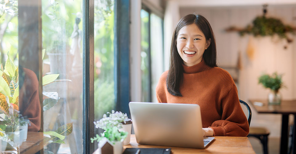 smiling woman working at a computer