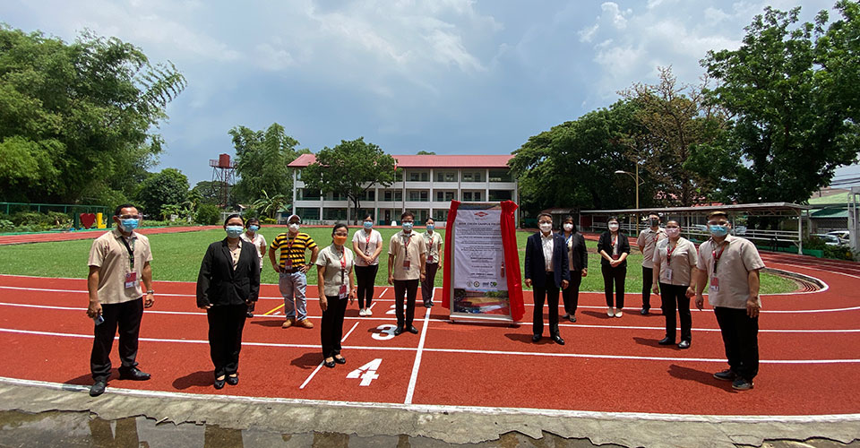 Team stands around recycled track